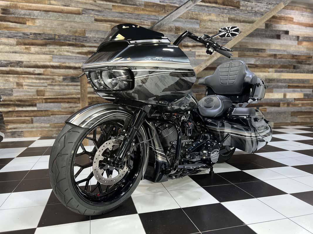 A sleek black and white motorcycle on display in a showroom.