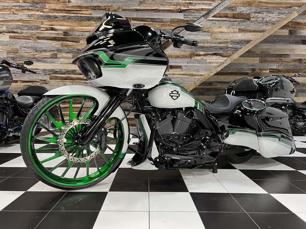 Green and black motorcycle parked in a room with a sleek design, ready for a thrilling ride.
