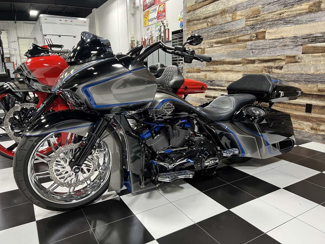 Several motorcycles parked in a showroom, one prominently displayed in the center.