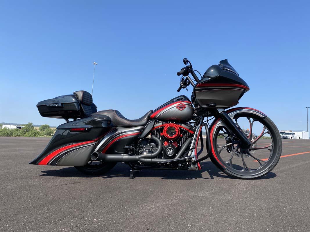Black and red motorcycle parked on lot, ready for a ride.